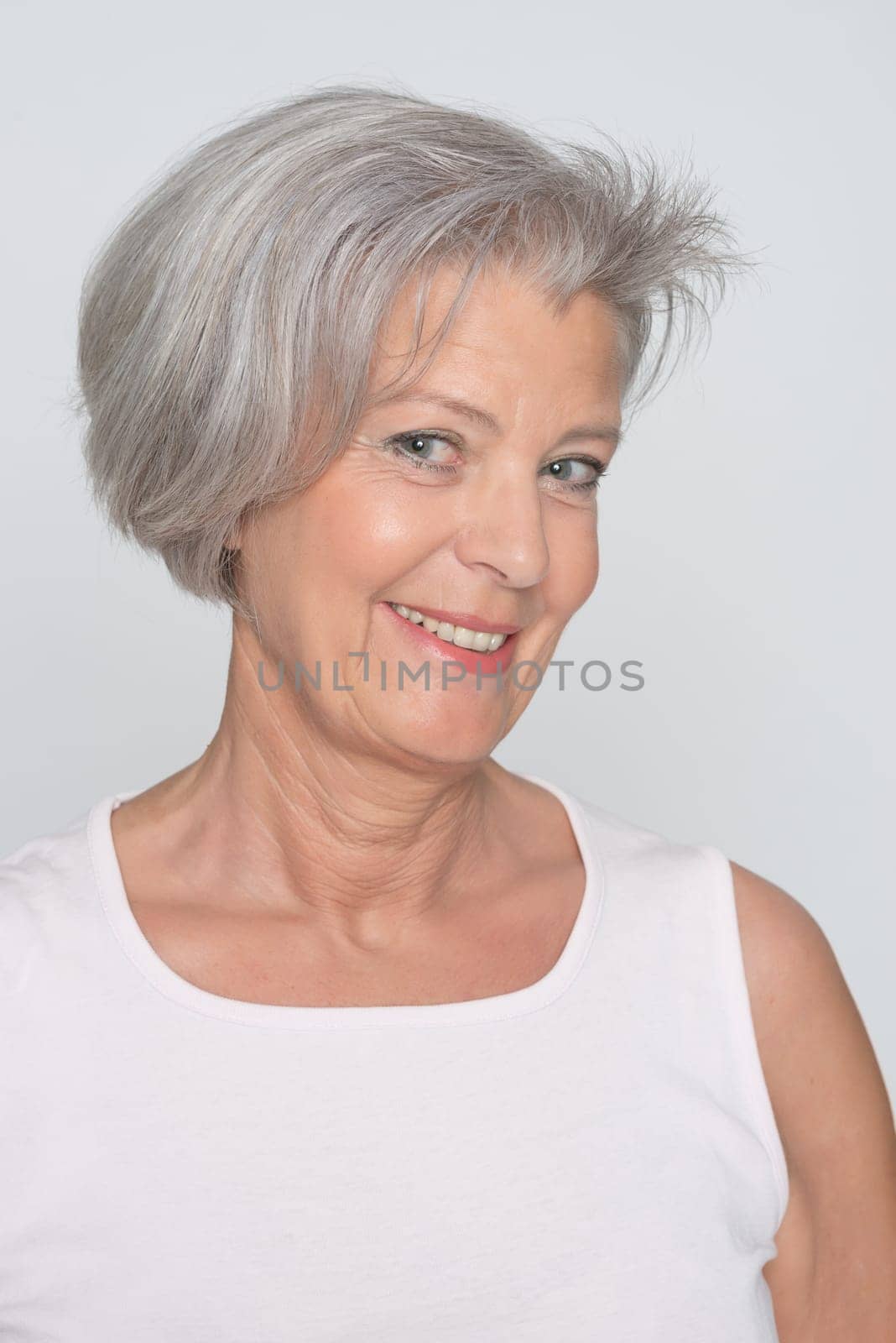 Middle-aged woman in front of gray background