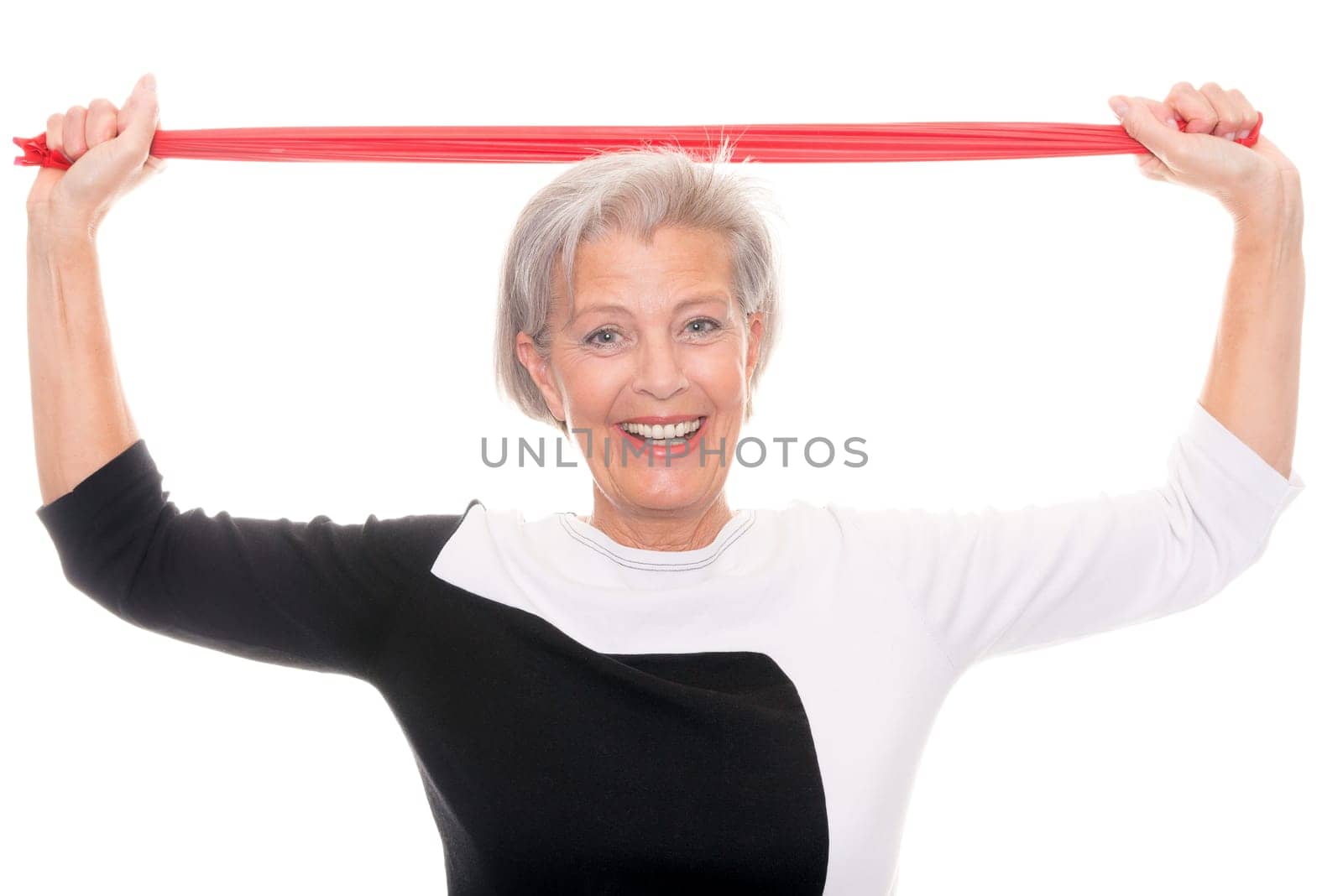 Active senior woman doing sports in front of white background