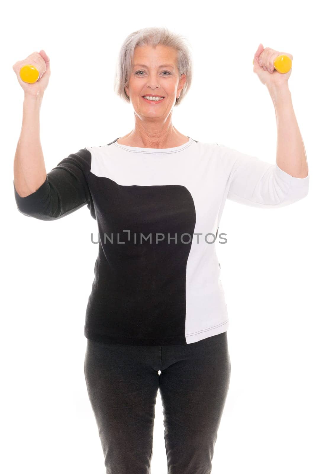 Active senior woman doing sports in front of white background