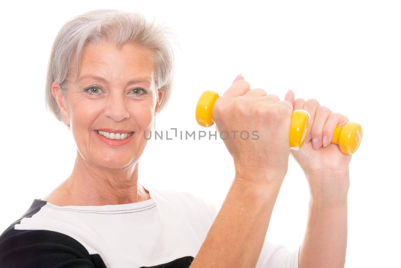 Active senior woman doing sports in front of white background