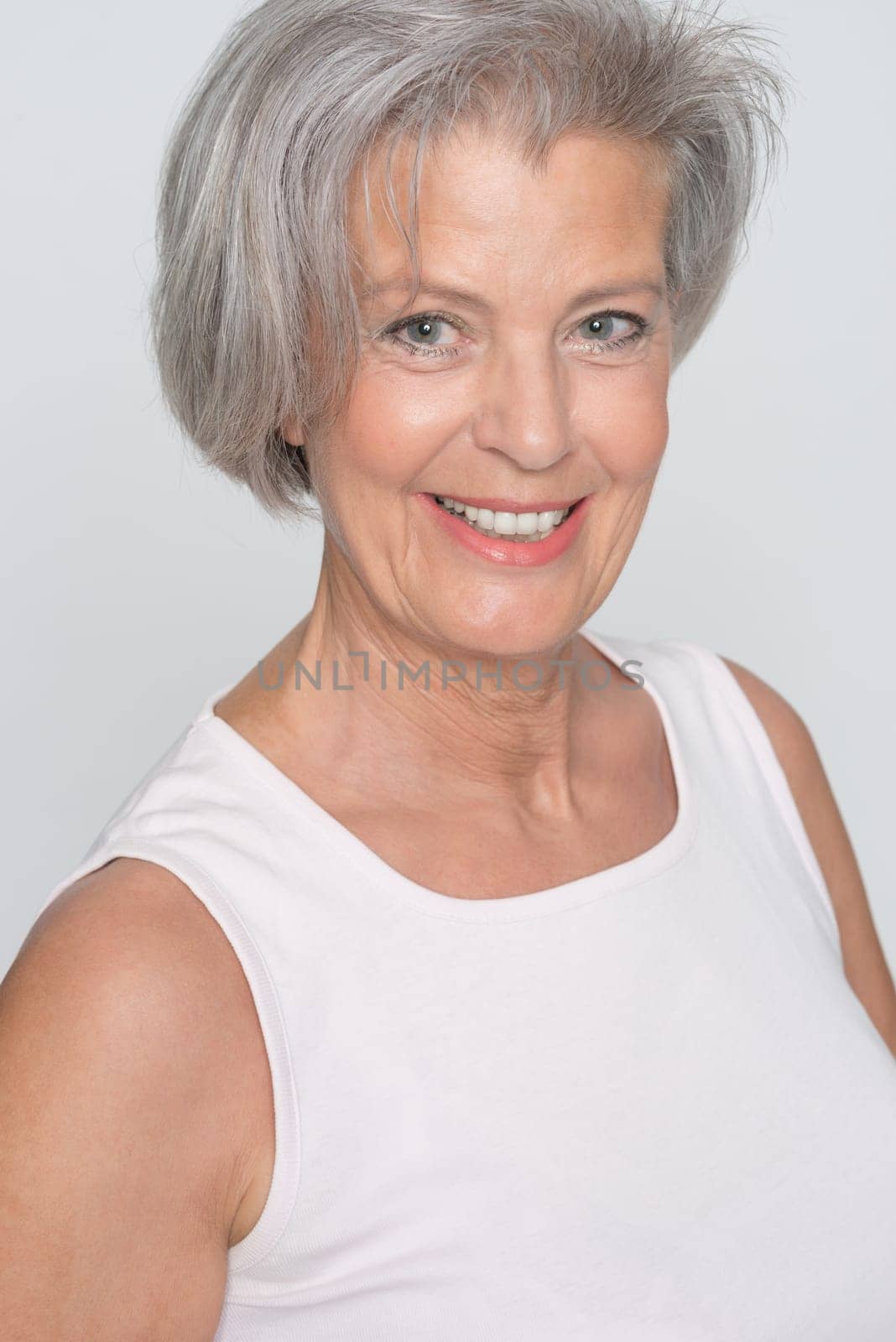 Middle-aged woman in front of gray background