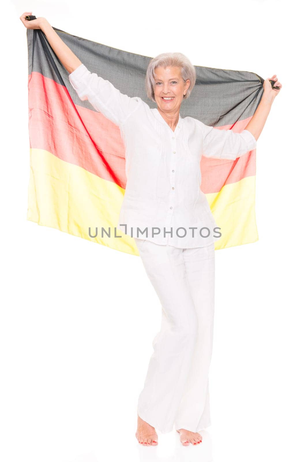 Senior woman as a German football fan in front of white background