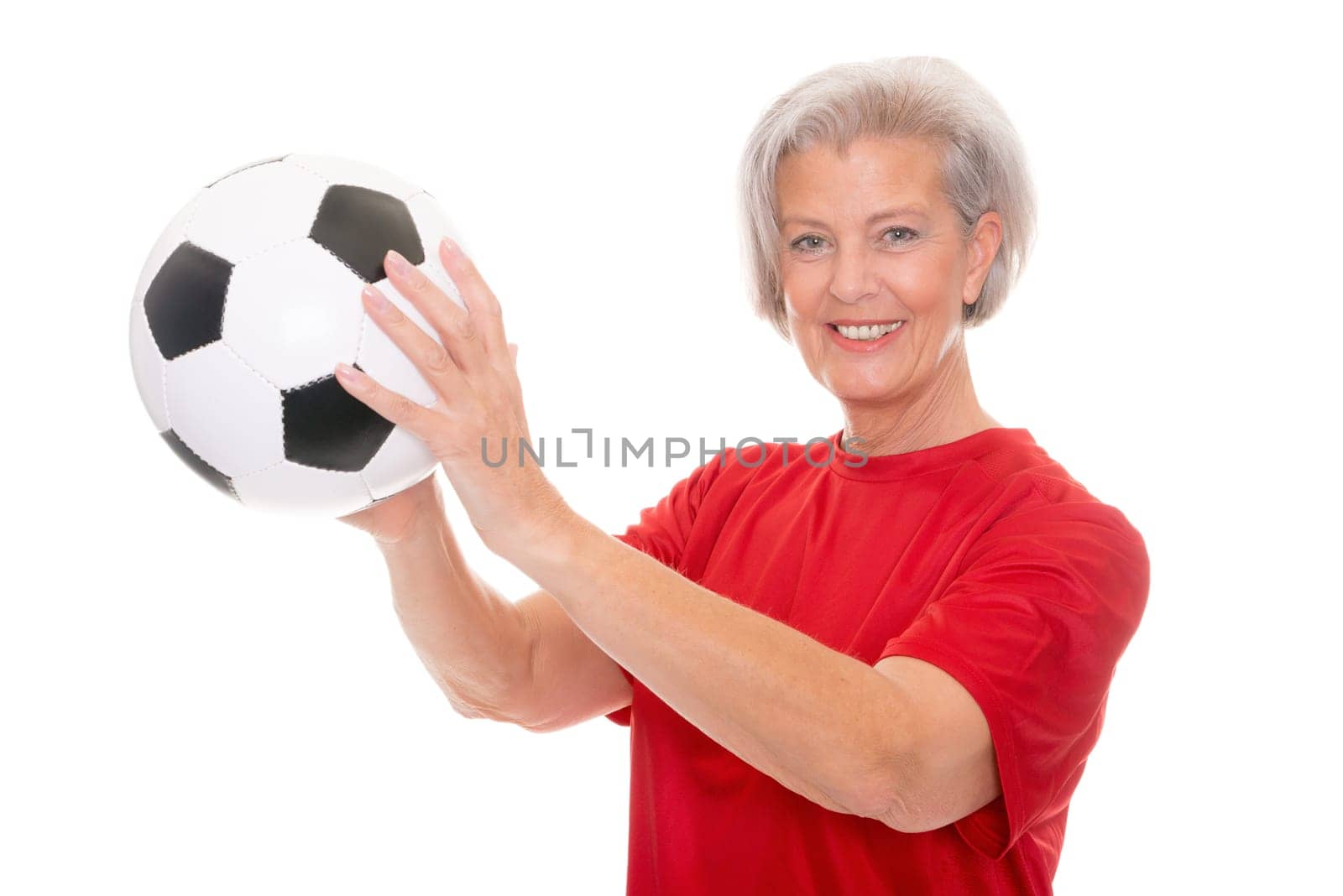 Active senior woman with a soccer ball