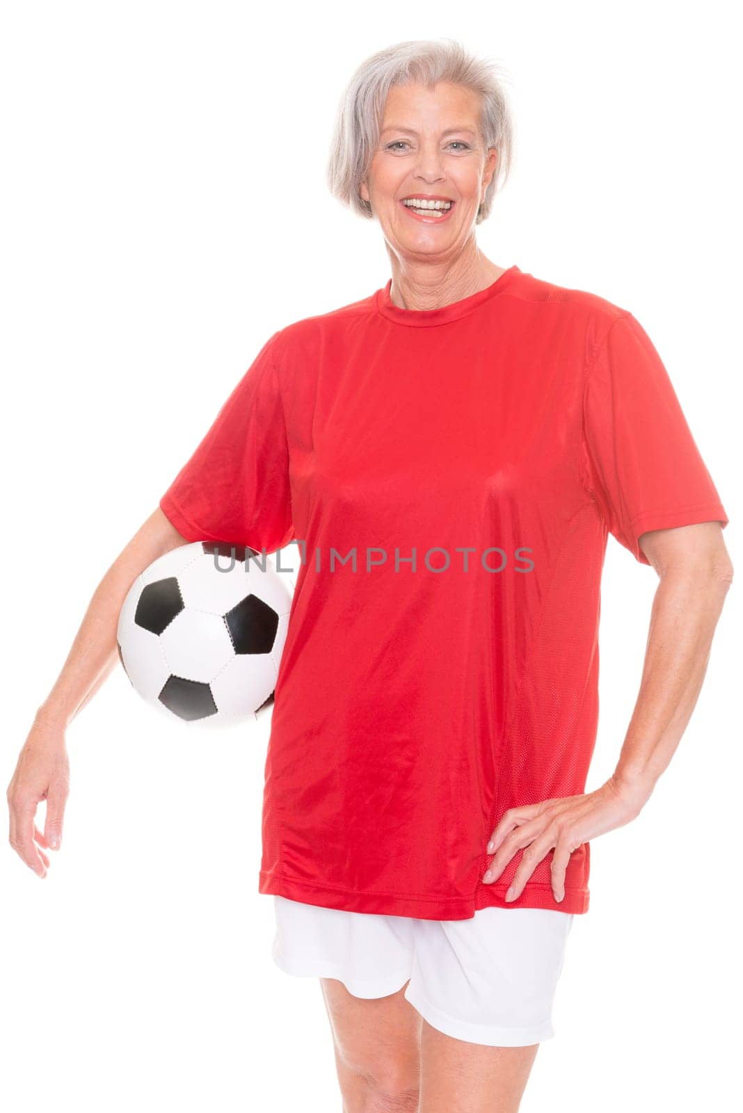 Active senior woman with a soccer ball