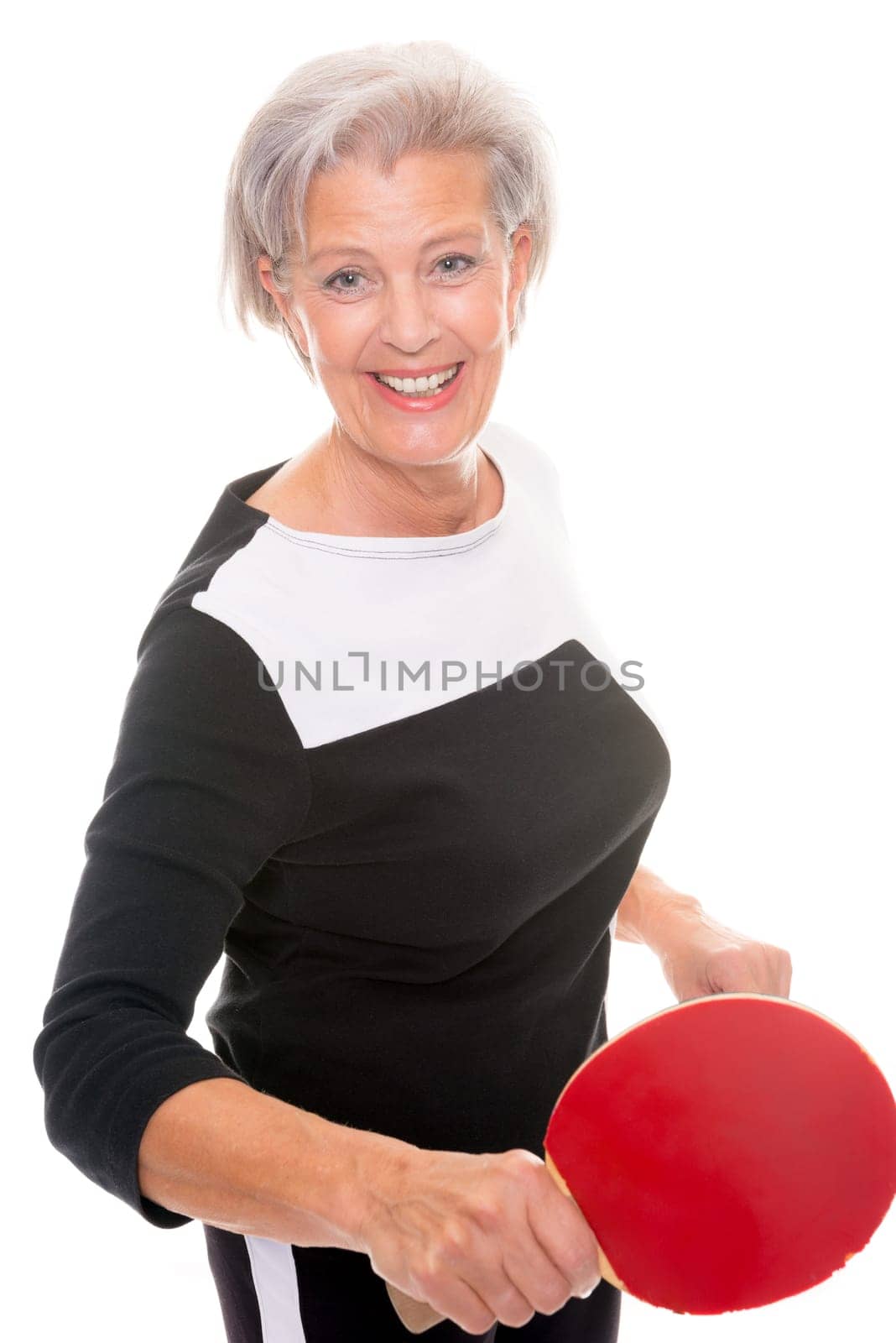 Active senior woman doing sports in front of white background