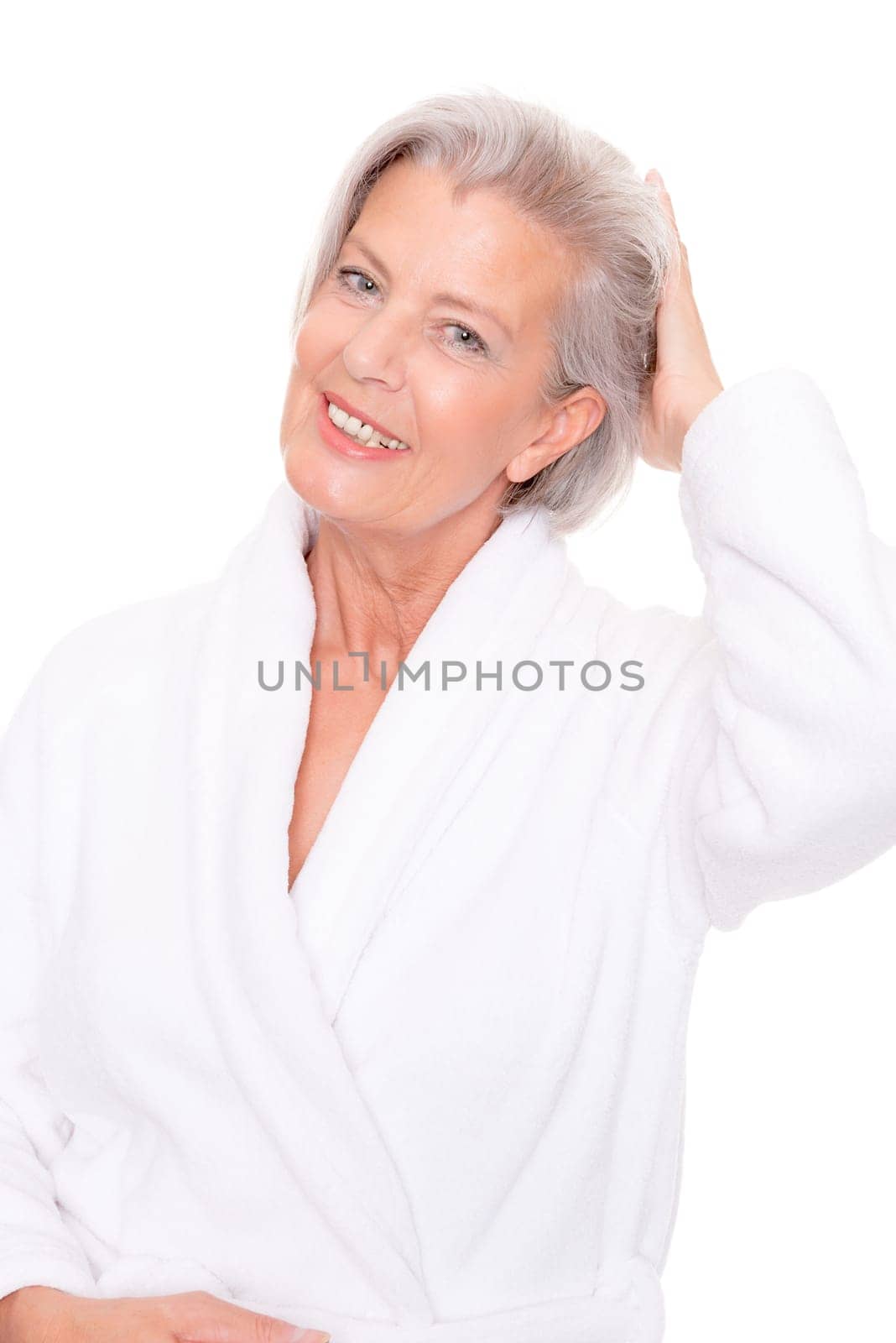 Studio shot of an elderly woman in a white bathrobe