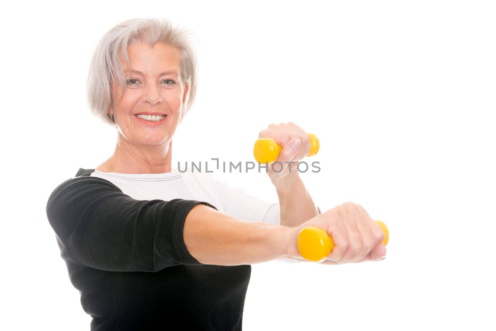 Active senior woman doing sports in front of white background
