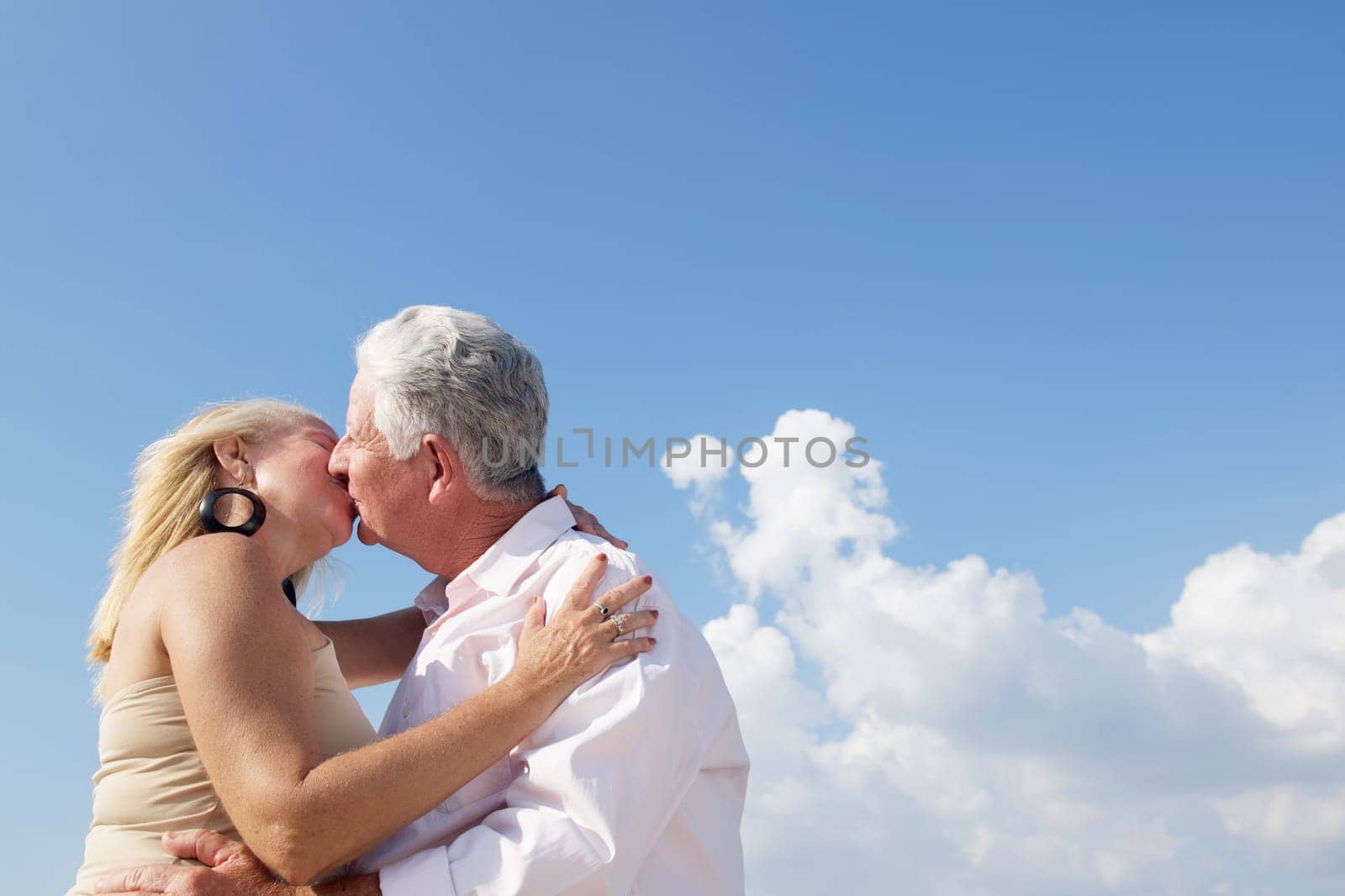 Elderly couple in love, honeymoon with old man and woman kissing. Copy space