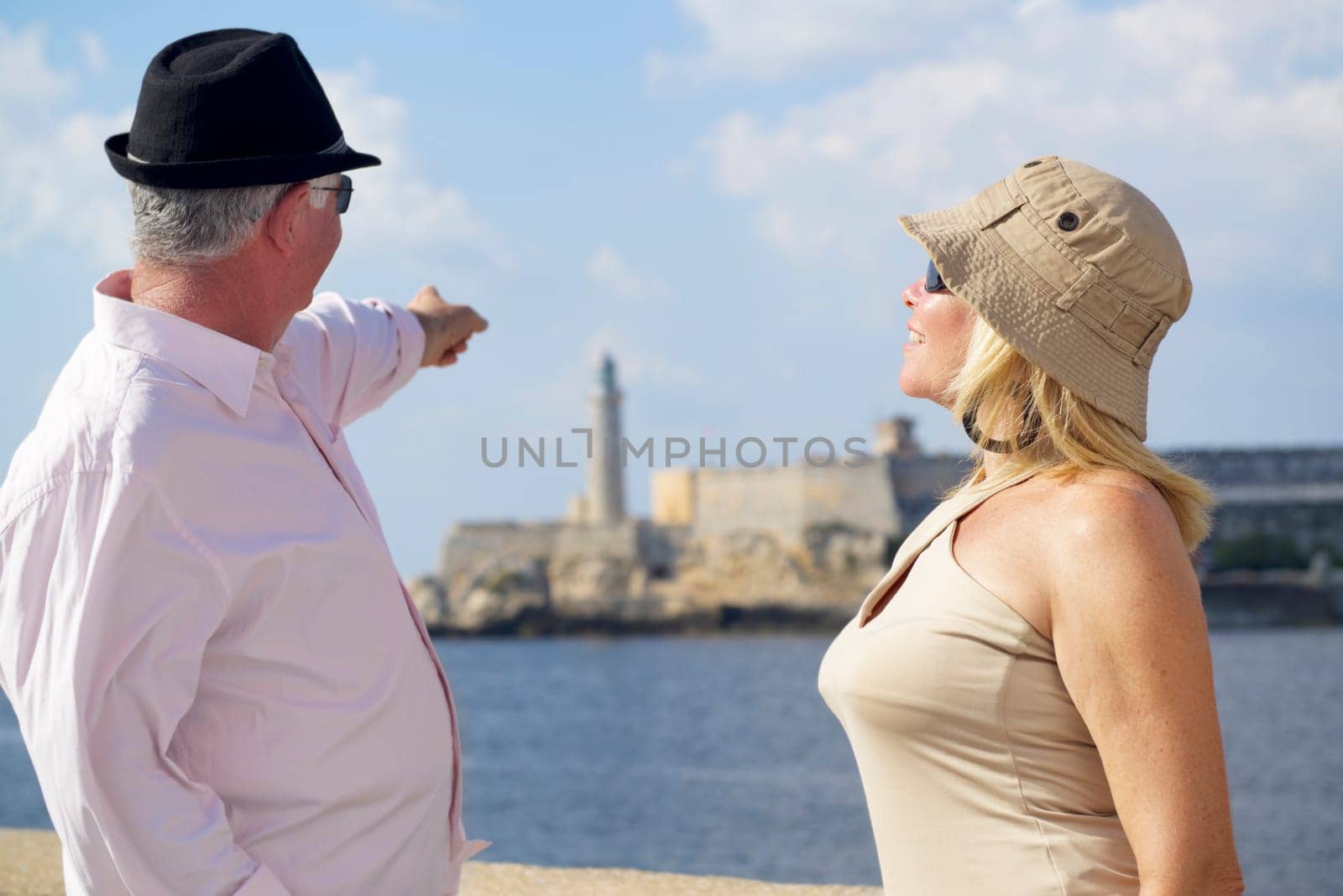 Tourism and active retirement with elderly people traveling, senior couple having fun on holidays in Havana, Cuba
