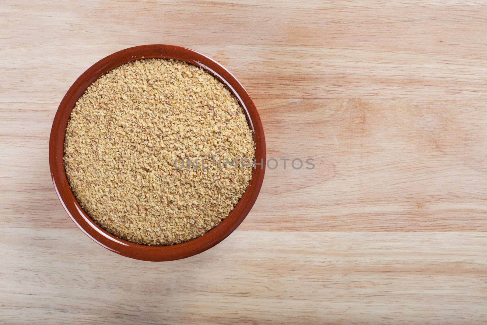 Bowl of wheat germ on wooden surface
