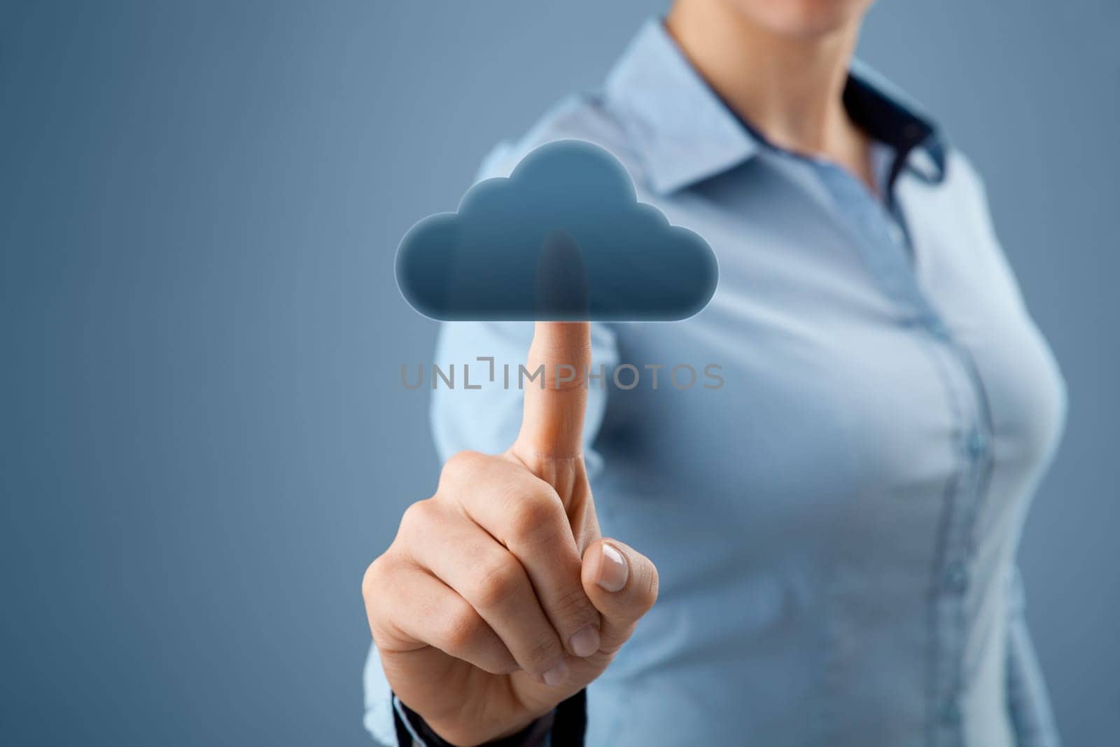 Cloud computing concept. Woman click on cloud icon ahead. Selective focused on finger and cloud.