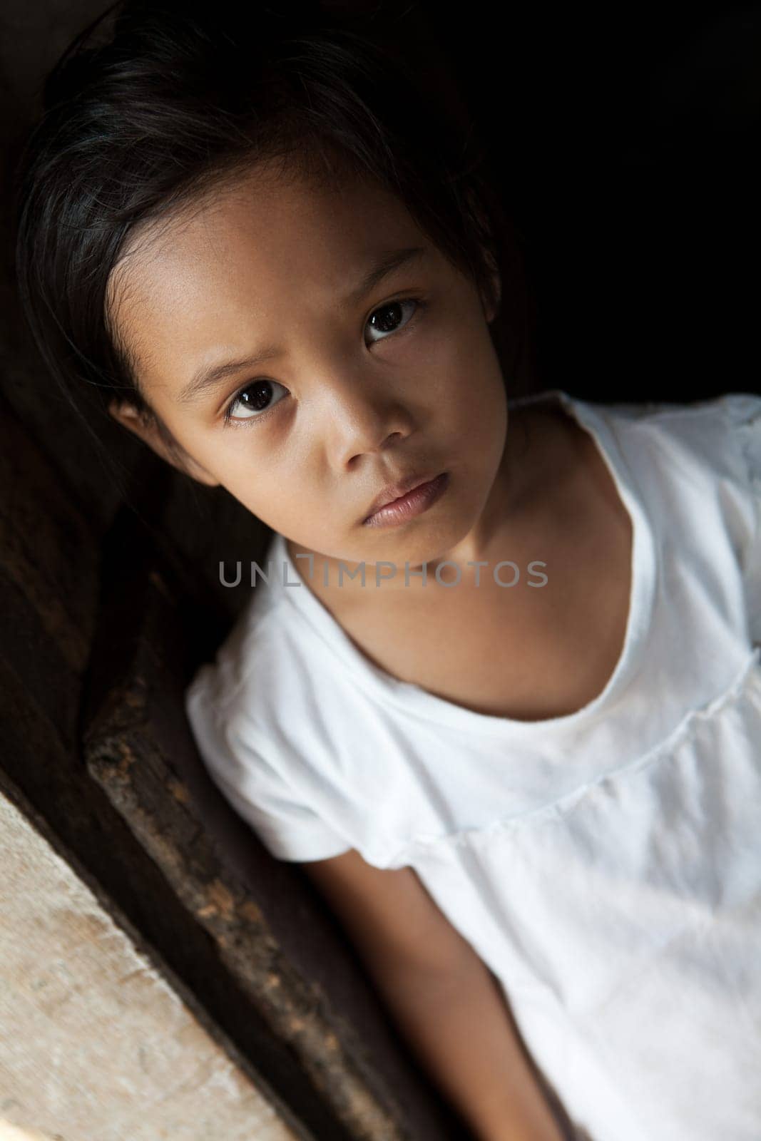 Asian young girl portrait in natural light - Filipina child from impoverished neighborhood in Philippines