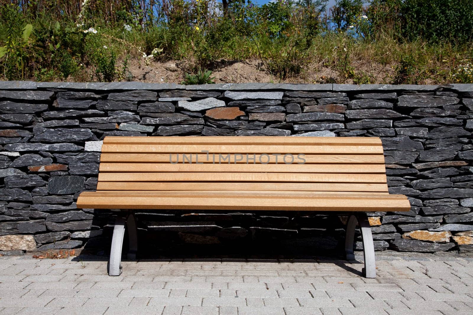 Wooden bench / garden bench in front of slate wall