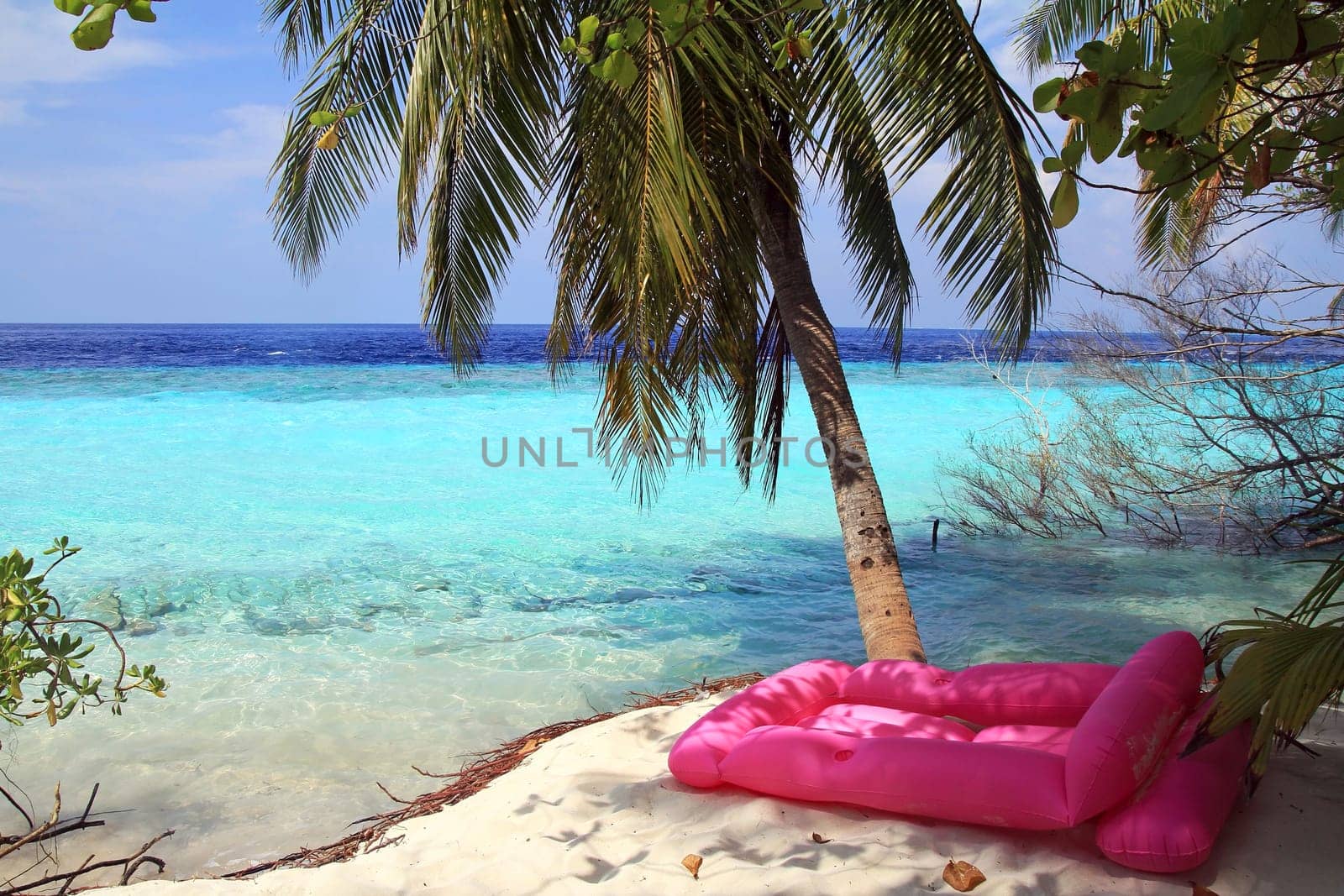 The pink air mattress at the blue sea