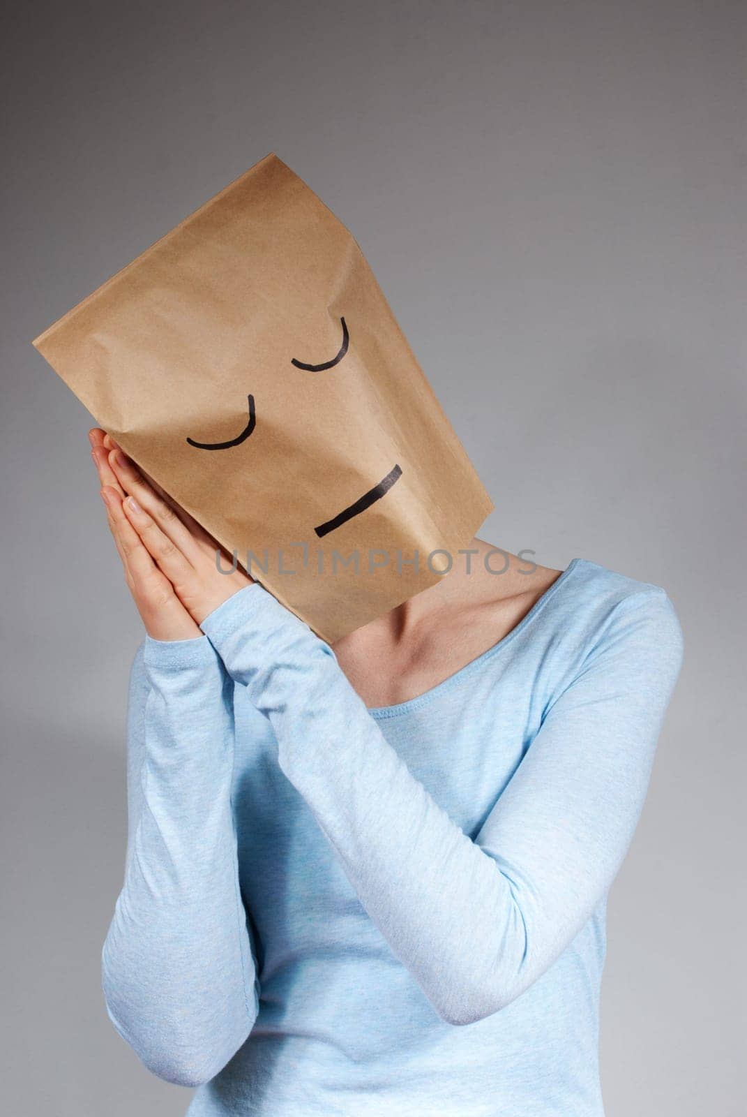 a person symbolizing tiredness, on gray background