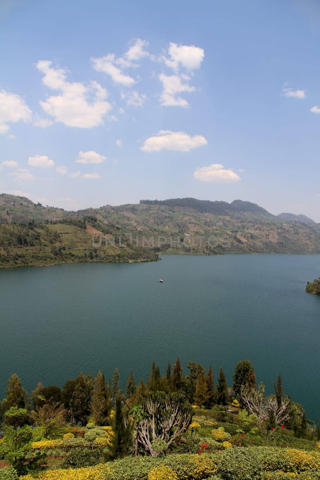 A pretty looking lake with surrounding hills on a beautiful sunny day