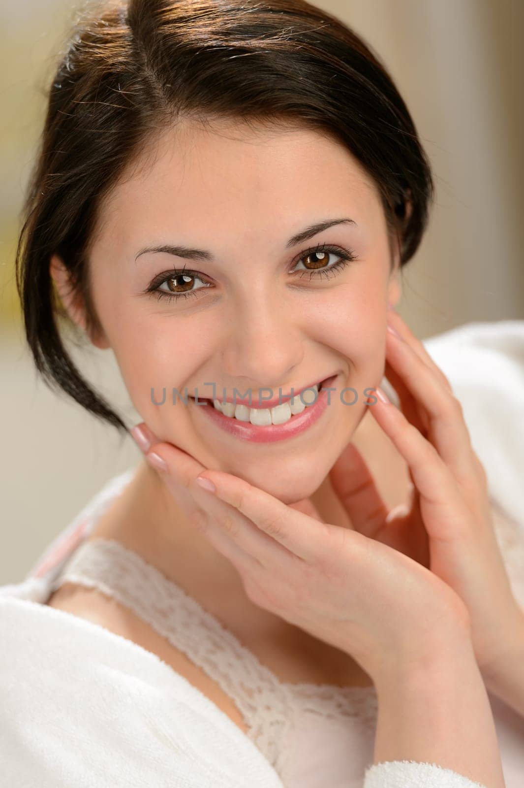 Delighted young woman stroking her face with hands