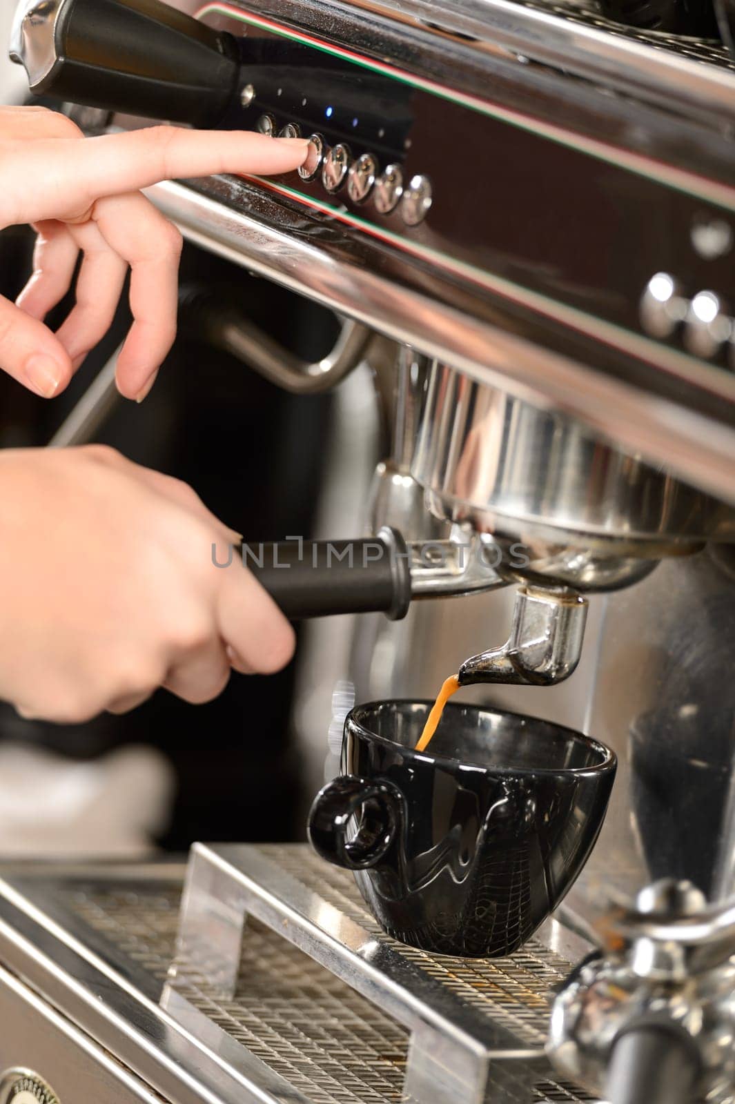 Close up of hands making coffee with espresso machine