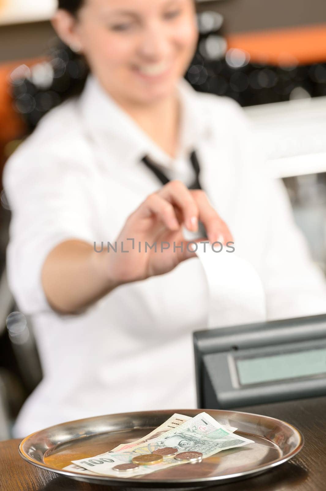 Cash and young cashier giving receipt in bar CZK