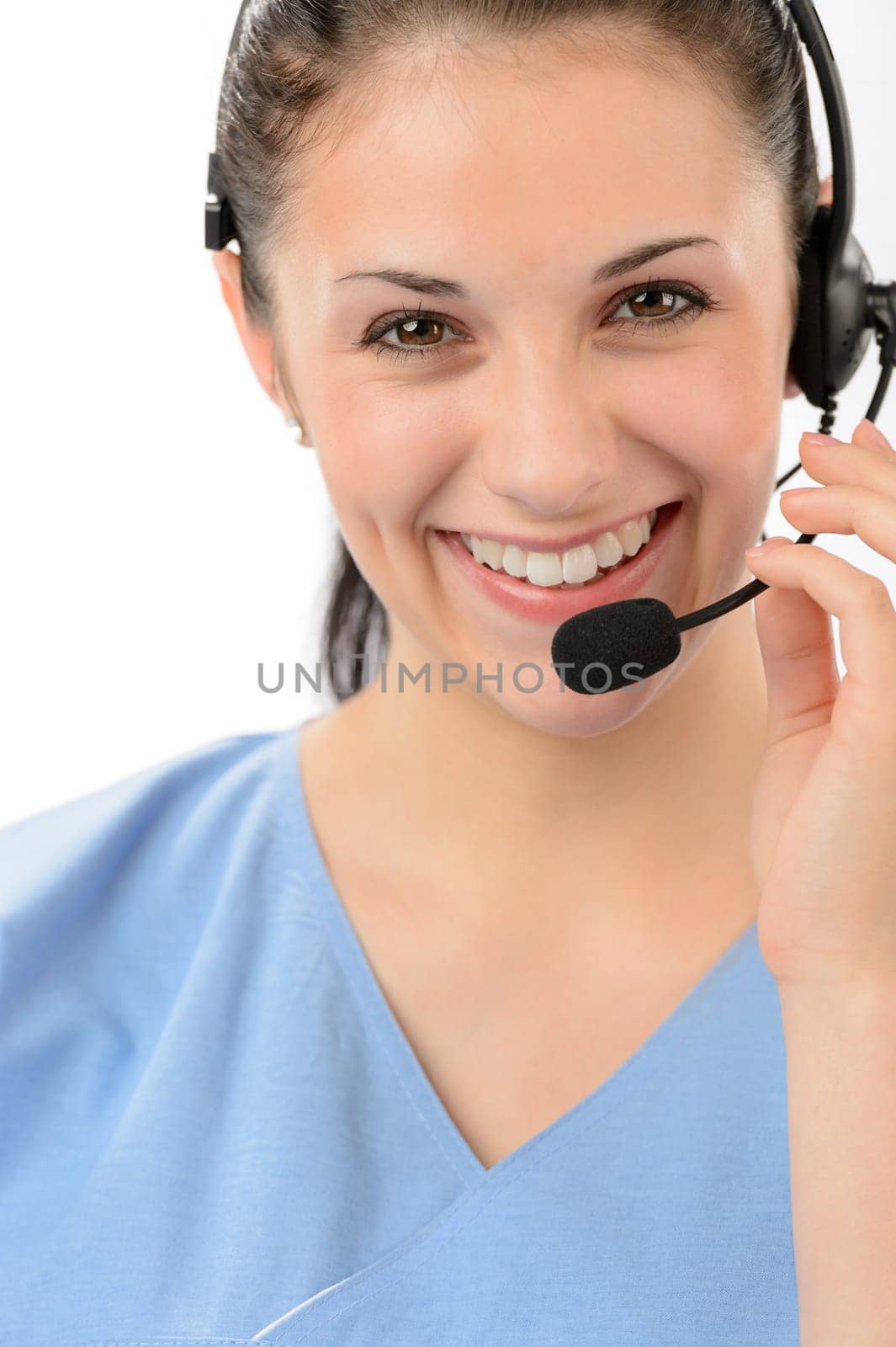 Smiling female customer support phone operator looking at camera