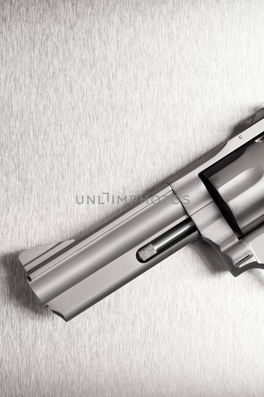 Gun on brushed metal background - a modern revolver.
