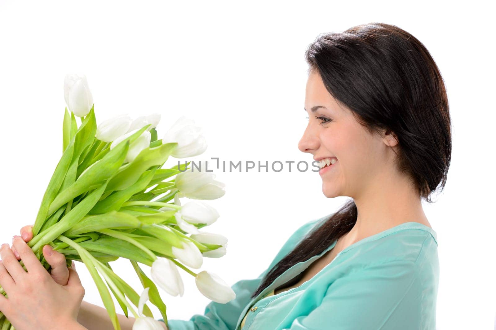 Elated young woman with bouquet of white flowers
