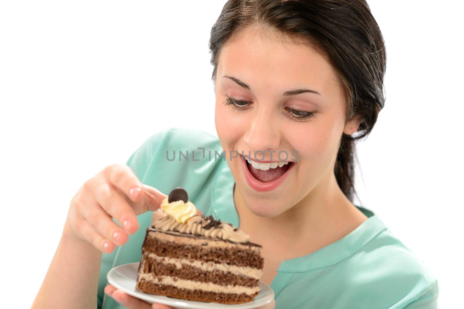 Joyful young girl eating tasty piece of cake