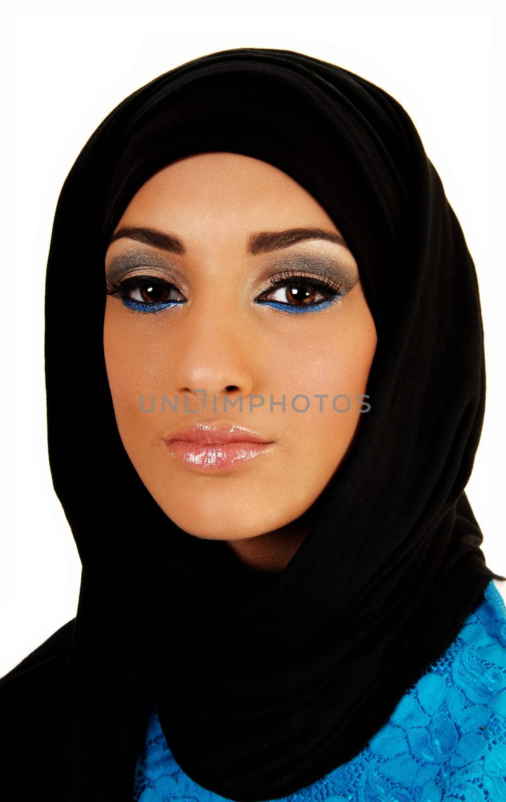 A pretty and young teen girl with a black headscarf and nice makeup looking into the camera for white background.