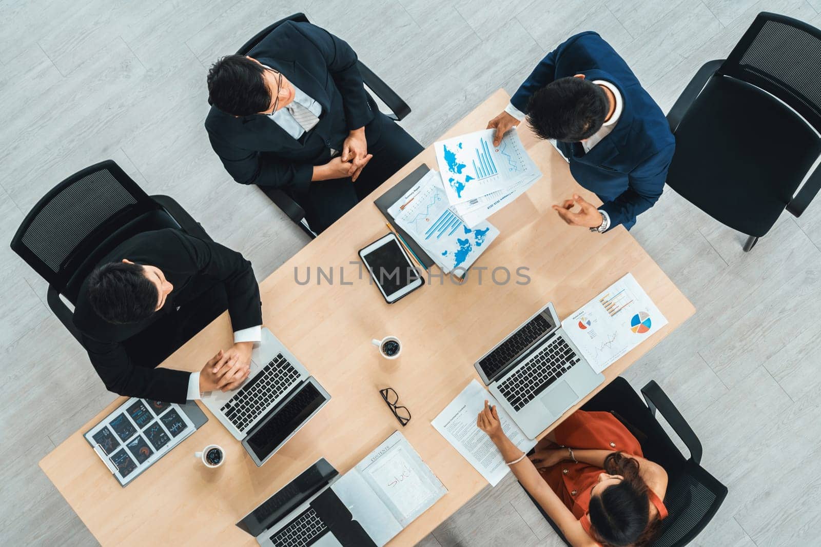 Business people group meeting shot from top view in office . Profession businesswomen, businessmen and office workers working in team conference with project planning document on meeting table . Jivy