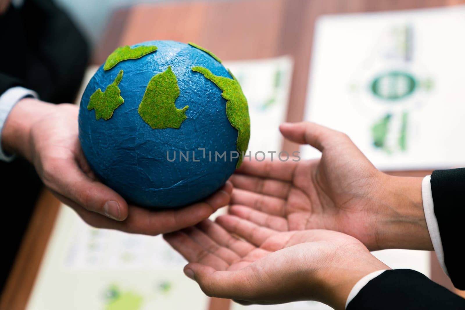 Top view business people holding Earth together in synergy as team building to utilize eco regulation for environmental protection by reducing CO2 emission to save Earth. Quaint