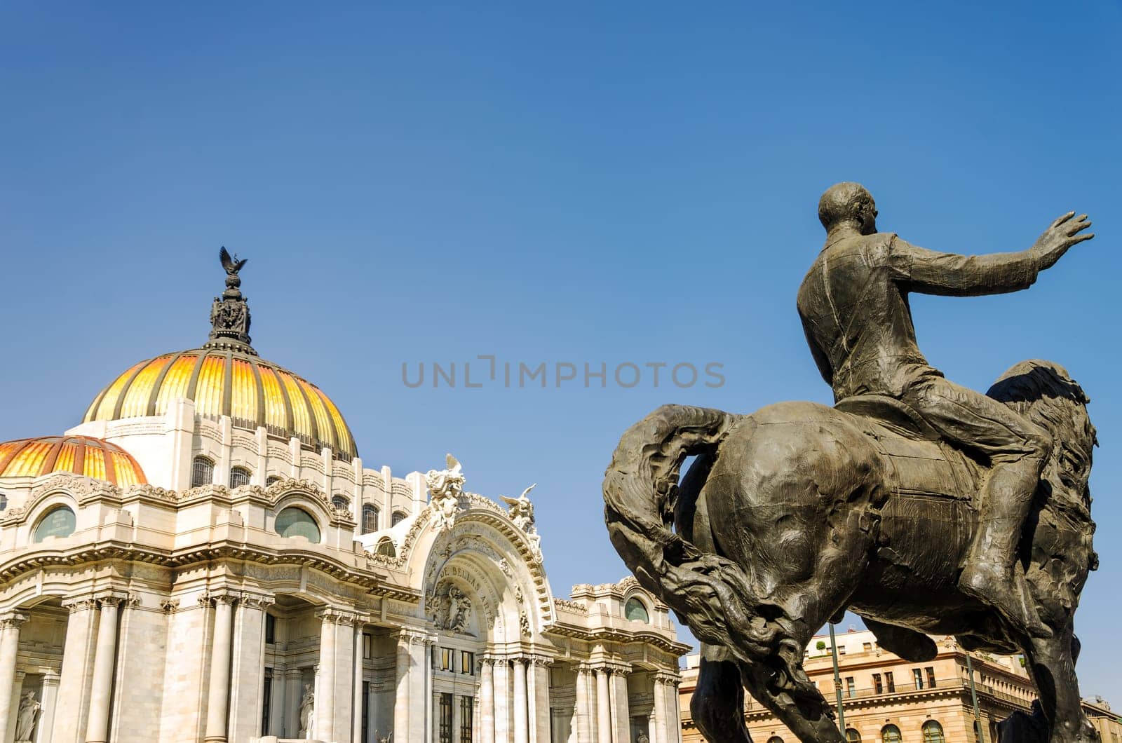 Palace of Fine Arts in Mexico City with a stature in the foreground
