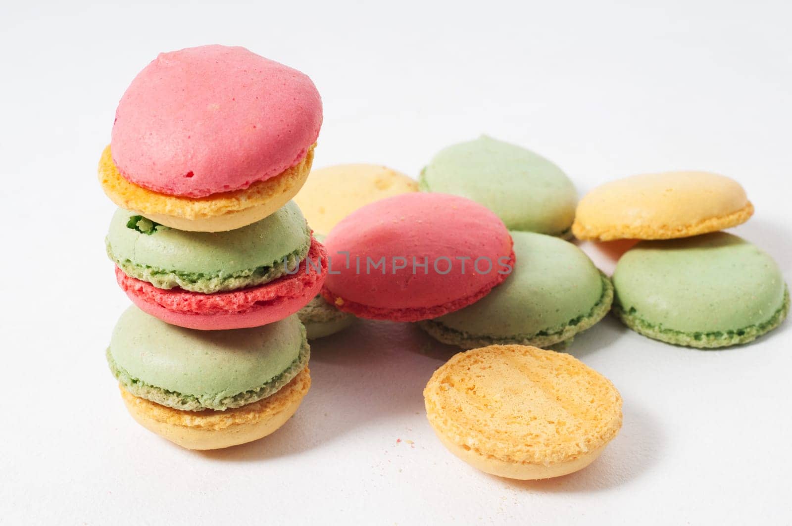 Multicolored macaron cookies on the light background