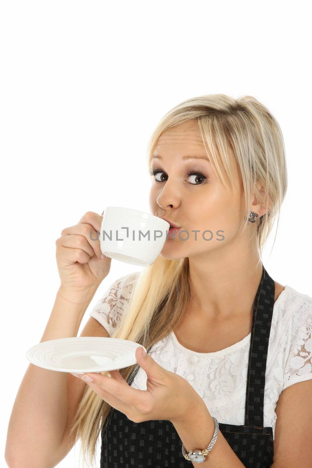 Lovely blond girl sipping a cup of hot beverage