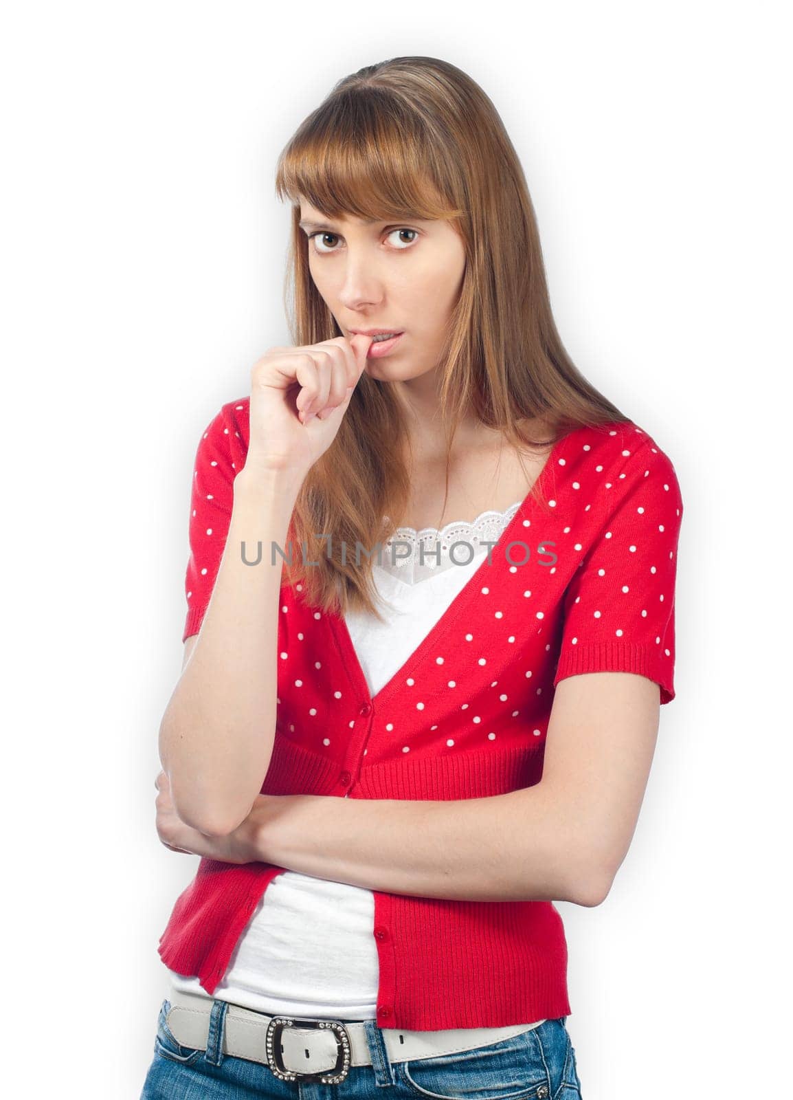 Beautiful worried young woman looking into the camera, finger at her mouth. Isolated on white background.