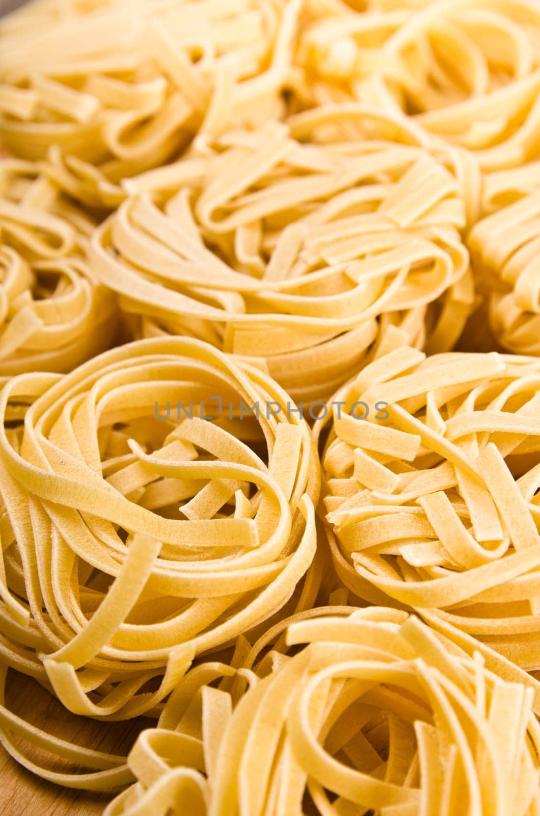 Raw tagliatelle close-up background