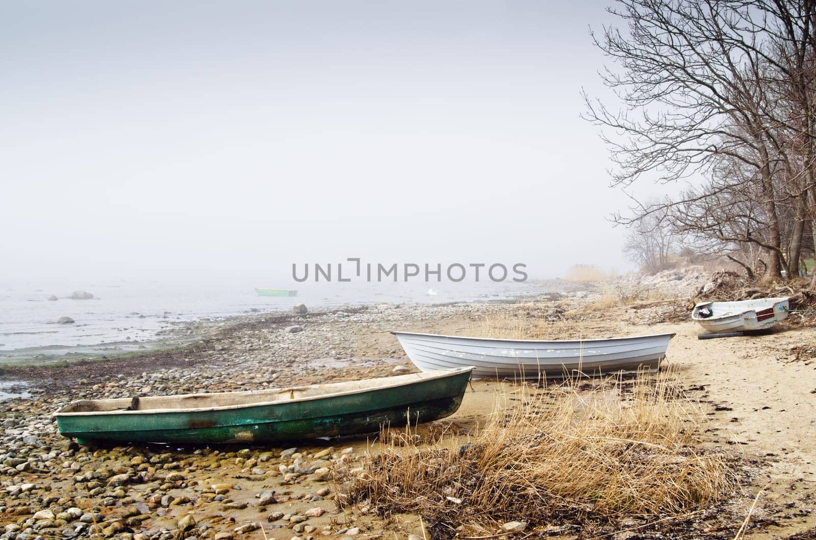 Old fishing boat at coast foggy in the morning
