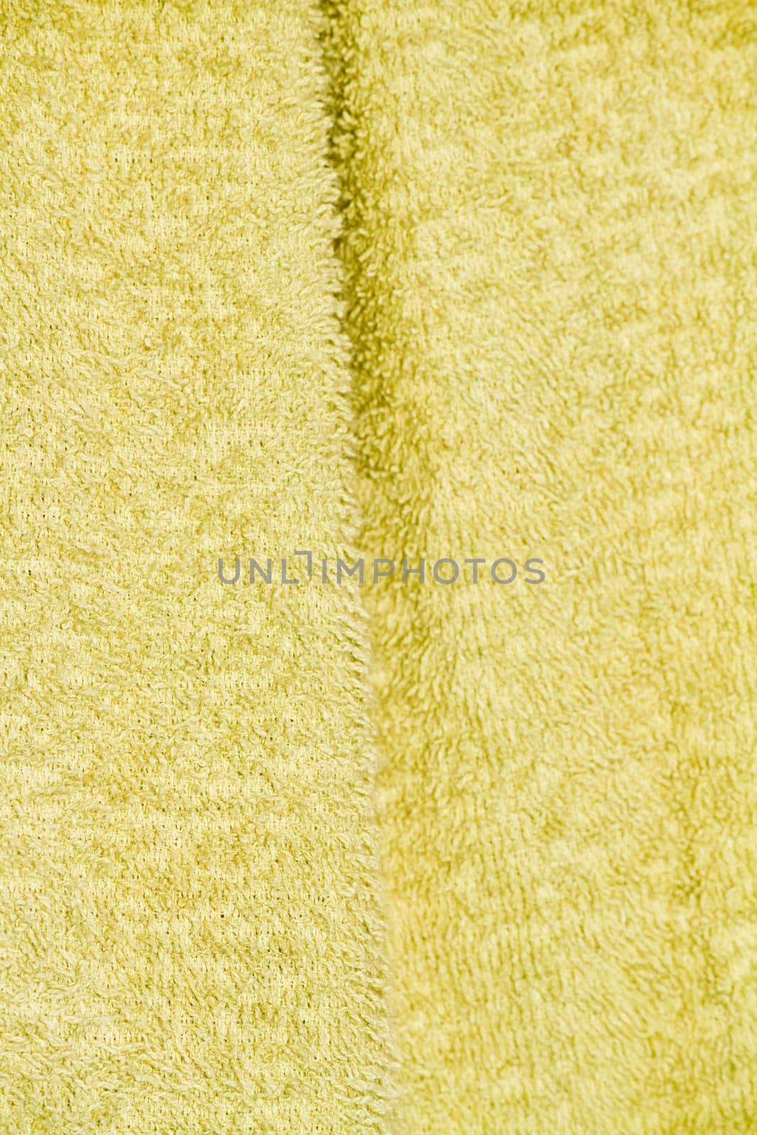 Close up view of the texture of a light green bathing towel.