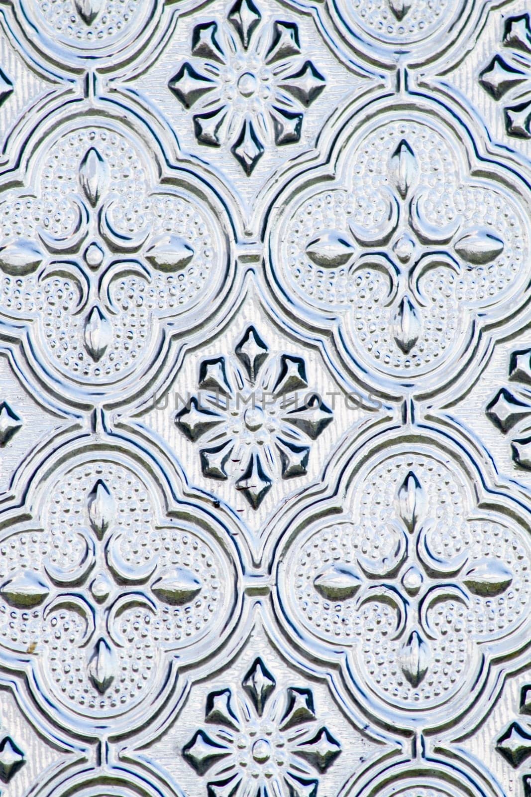 Close view of the flower texture in a glass window.