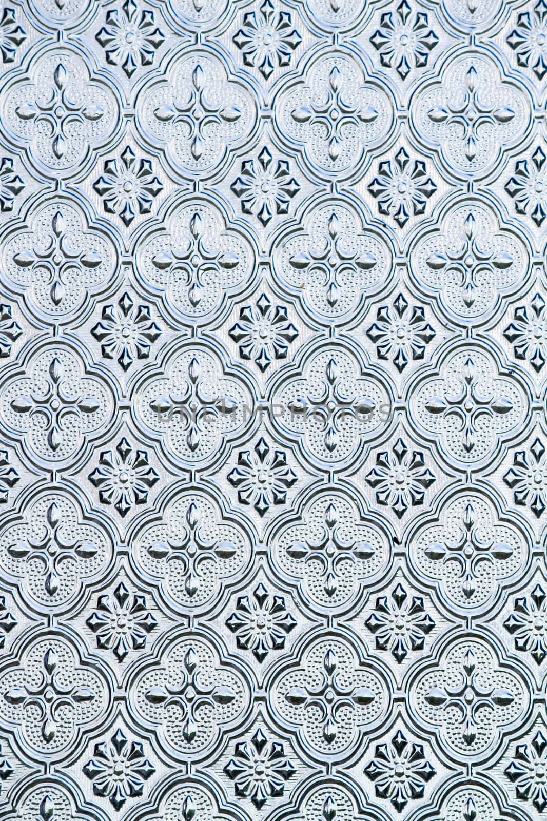 Close view of the flower texture in a glass window.