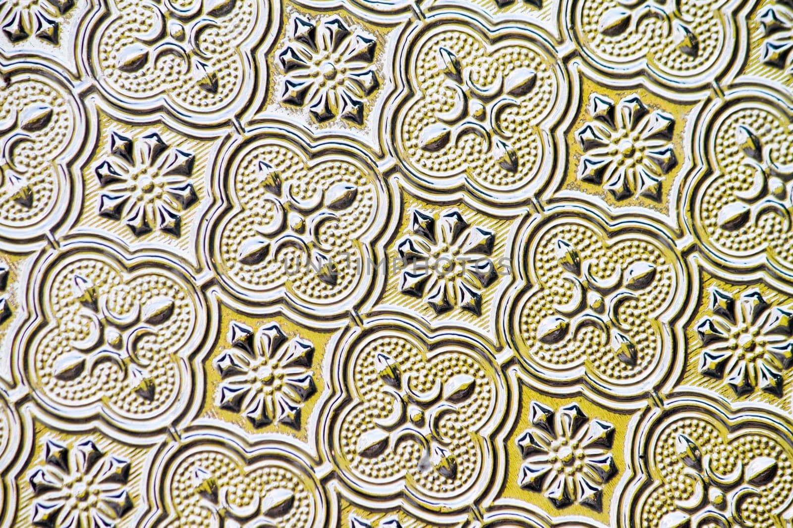 Close view of the flower texture in a glass window.