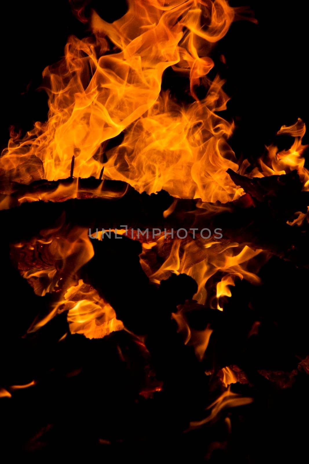 Close view of a wood fire at night.