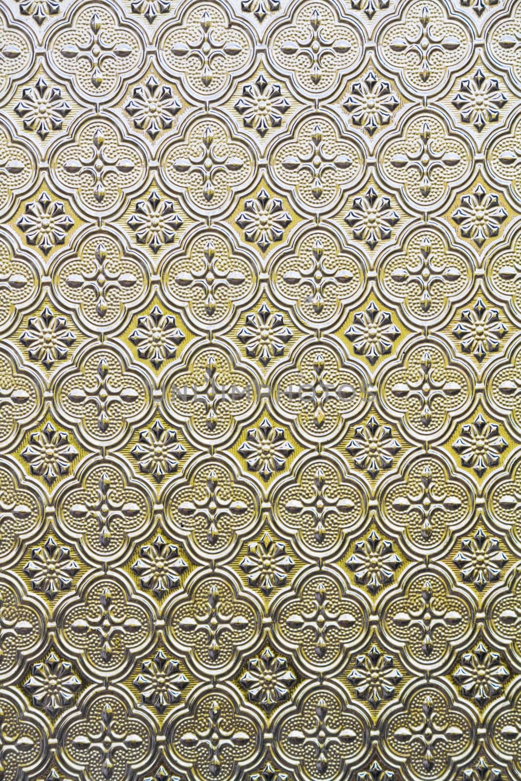 Close view of the flower texture in a glass window.