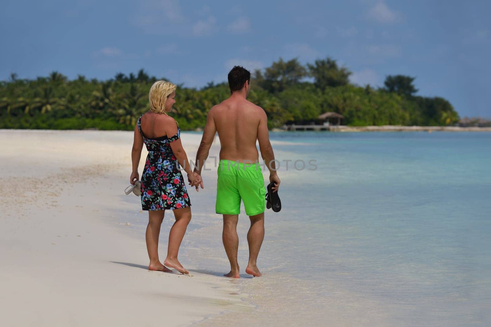happy young  couple at summer vacation have fun and relax at beautiful sunny  day on beach