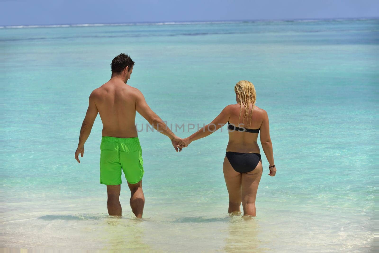 happy young  couple at summer vacation have fun and relax at beautiful sunny  day on beach