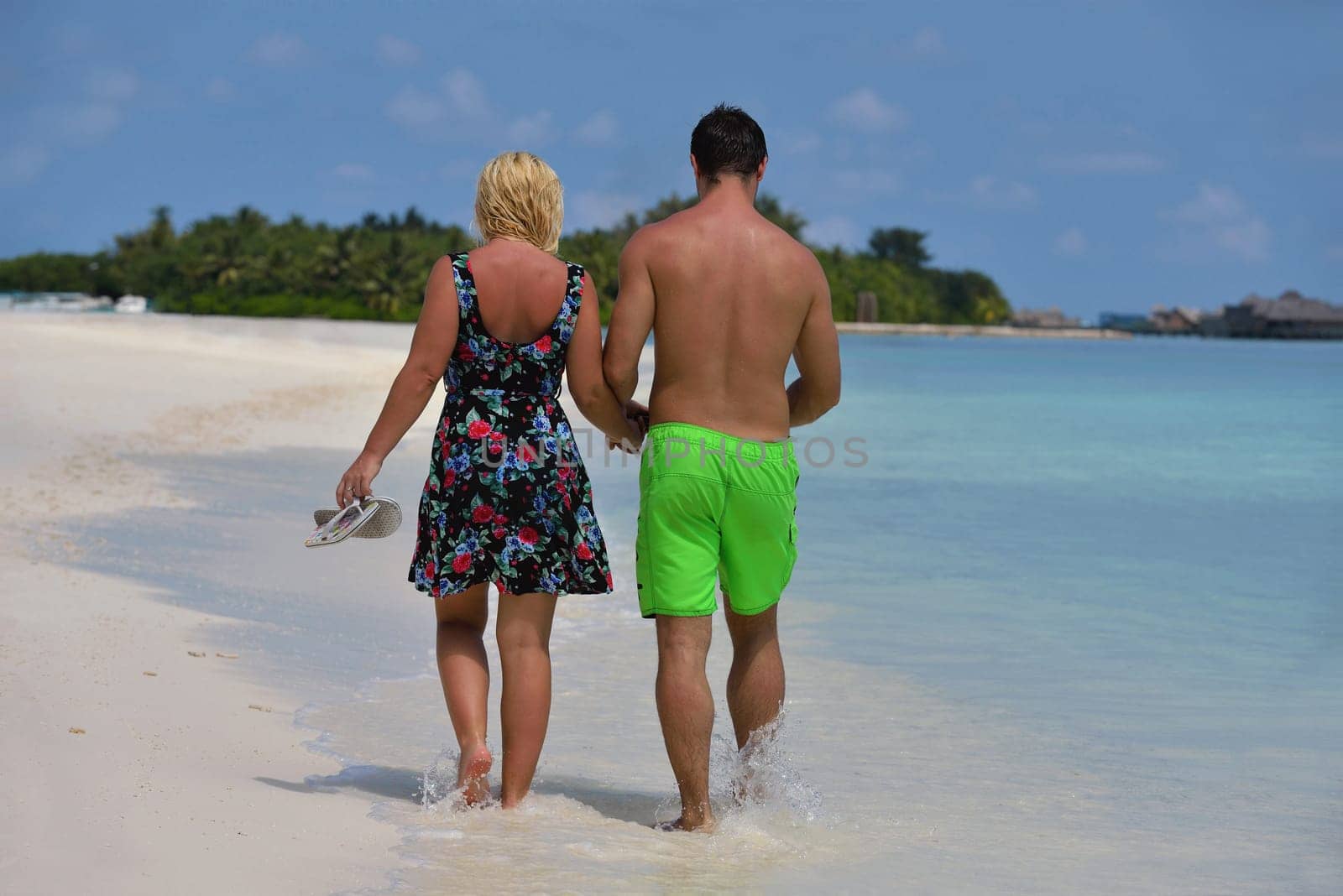 happy young  couple at summer vacation have fun and relax at beautiful sunny  day on beach