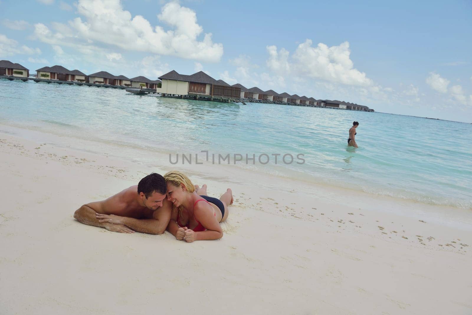 happy young  couple at summer vacation have fun and relax at beautiful sunny  day on beach