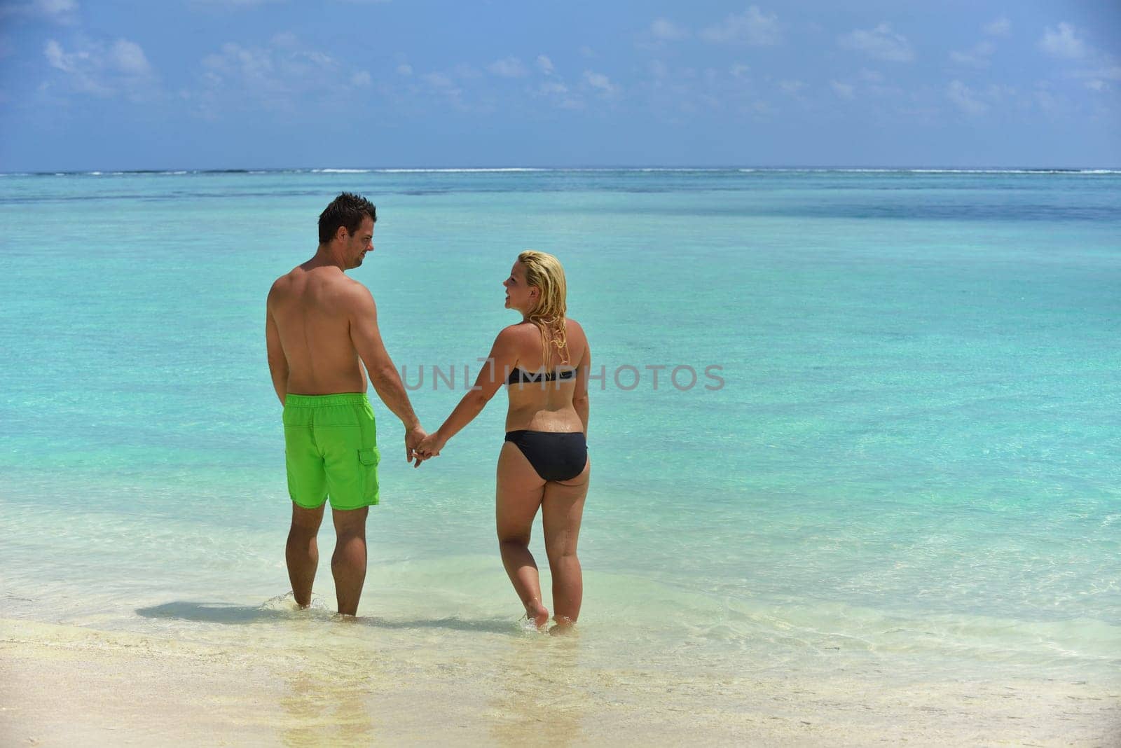 happy young  couple at summer vacation have fun and relax at beautiful sunny  day on beach