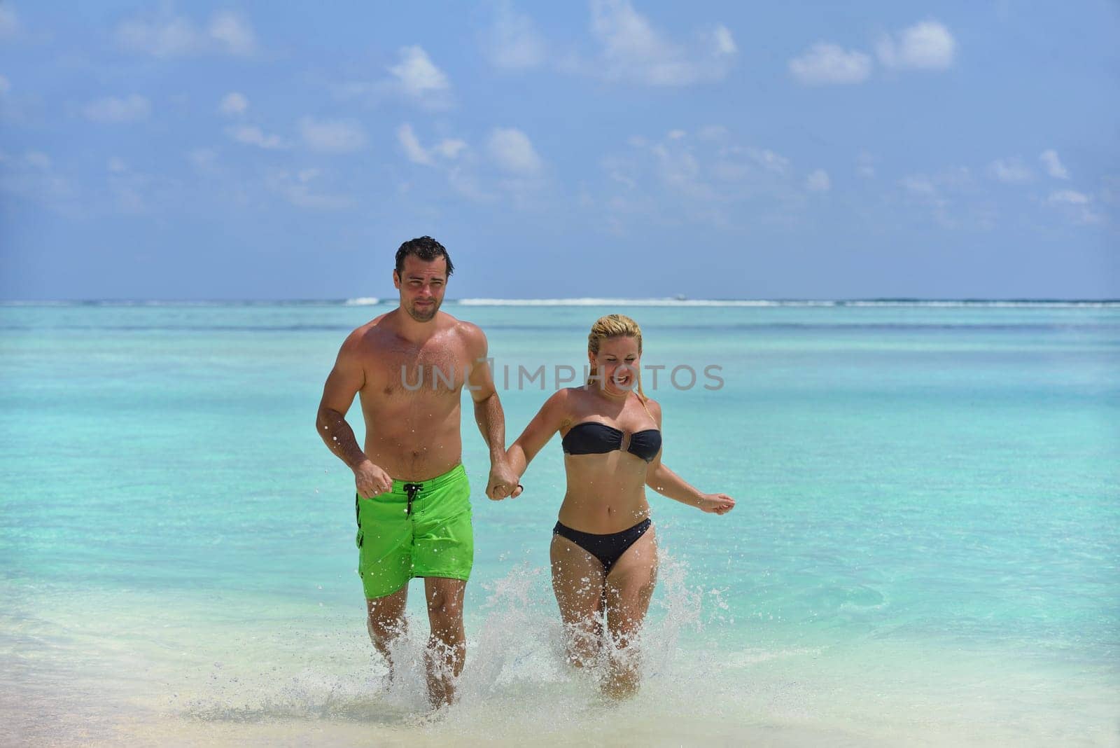 happy young  couple at summer vacation have fun and relax at beautiful sunny  day on beach