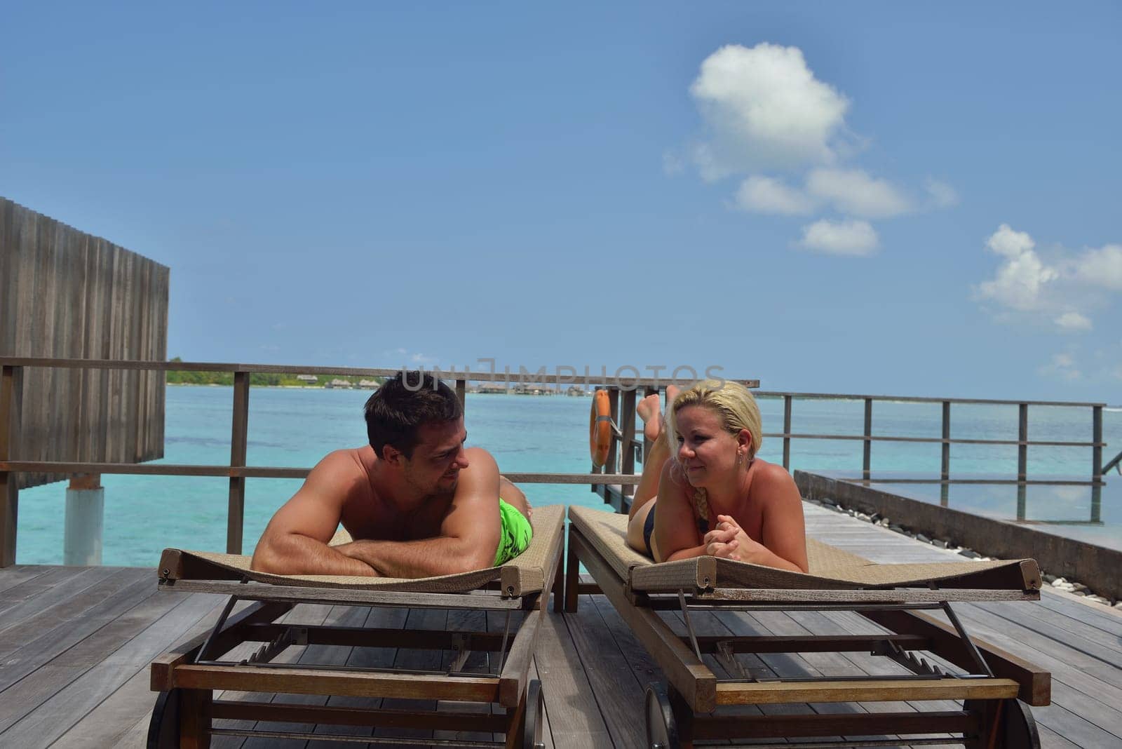 happy young  couple at summer vacation have fun and relax at beautiful sunny  day on beach