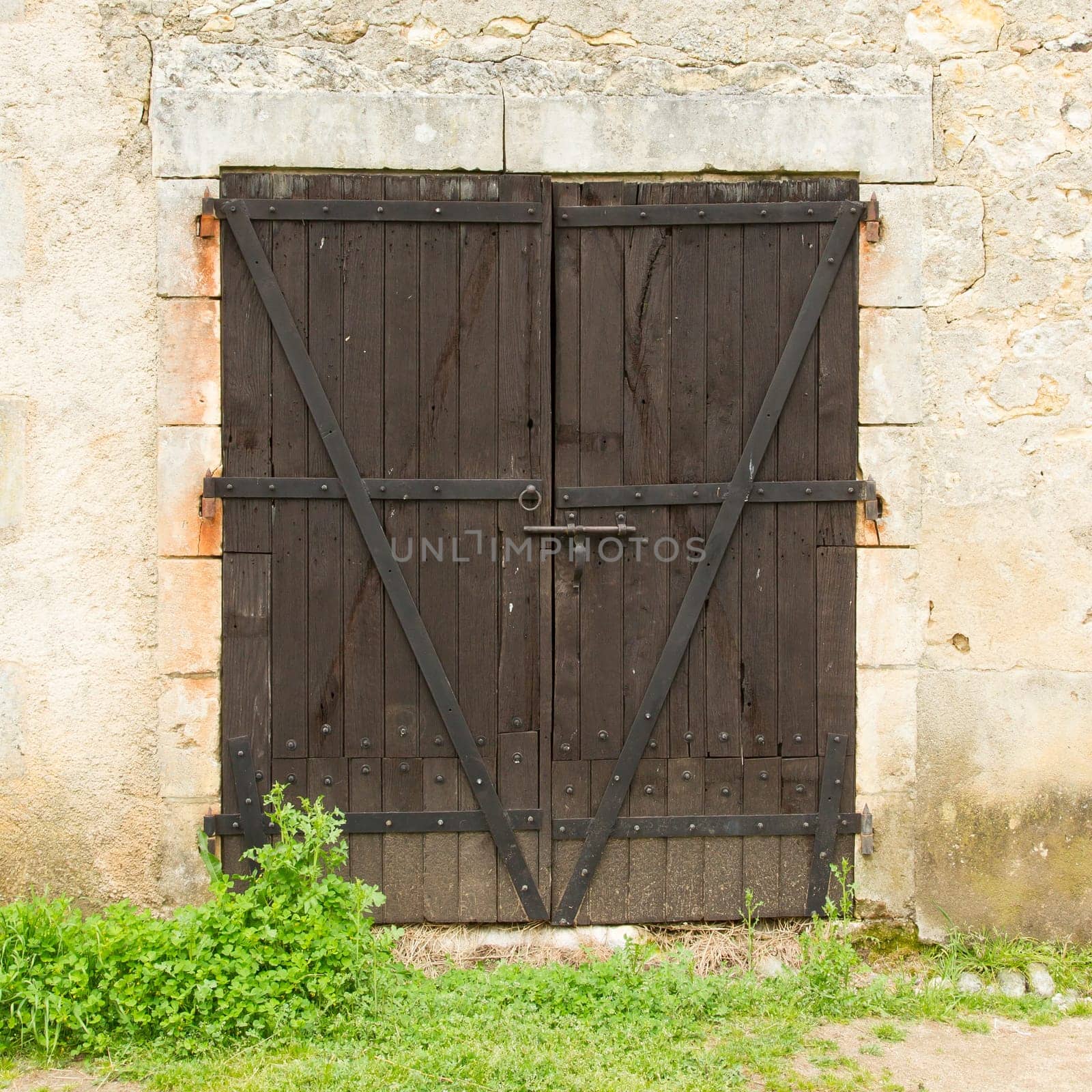 Old wooden door in an old stone wall